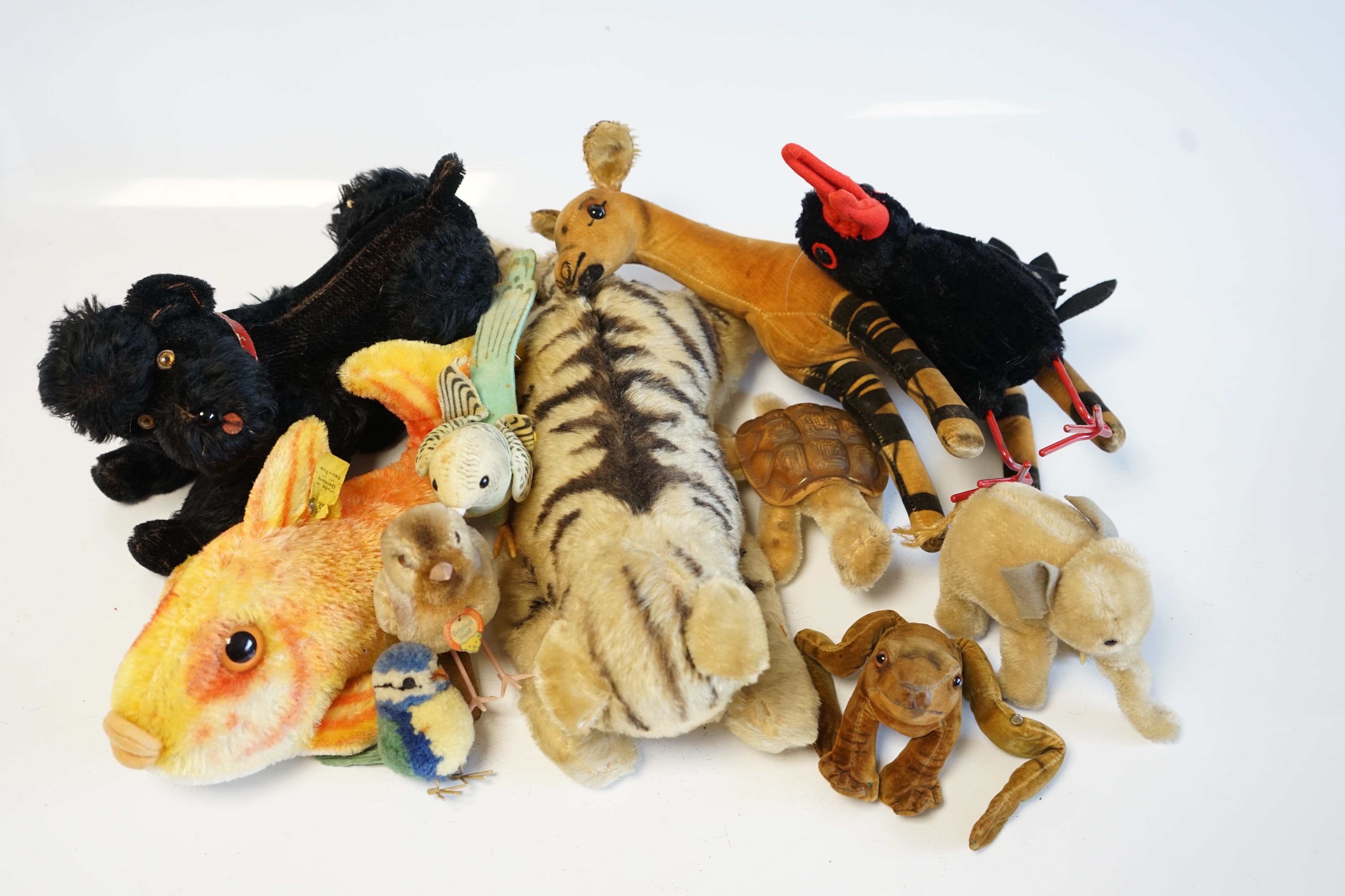 Eleven assorted 1960's Steiff toys, including Knobby the poodle, a large goldfish and various birds. Condition - fair